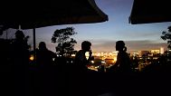 People sit on the terrace of a closed bar at the Monte Agudo viewpoint overlooking Lisbon during a nationwide power outage, 28 April, 2025