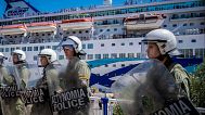 Riot police stand guard during the arrival of a ship carrying Israeli tourists on the island of Crete, 29 July, 2025