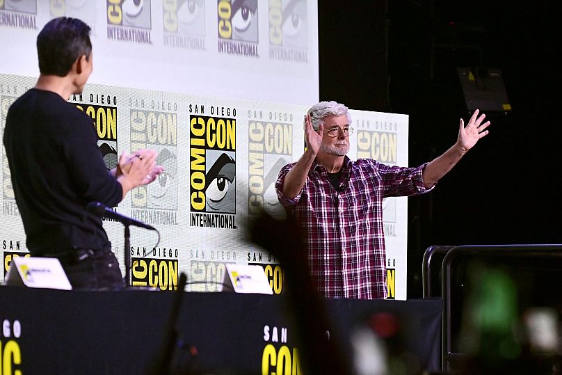 George Lucas, right, greets the crowd during a panel for the Lucas Museum of Narrative Art during Comic-Con International on 27 July 2025, in San Diego.
