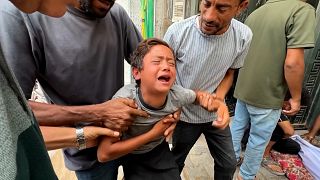 Grieving Gaza boy cries for his father killed near aid site