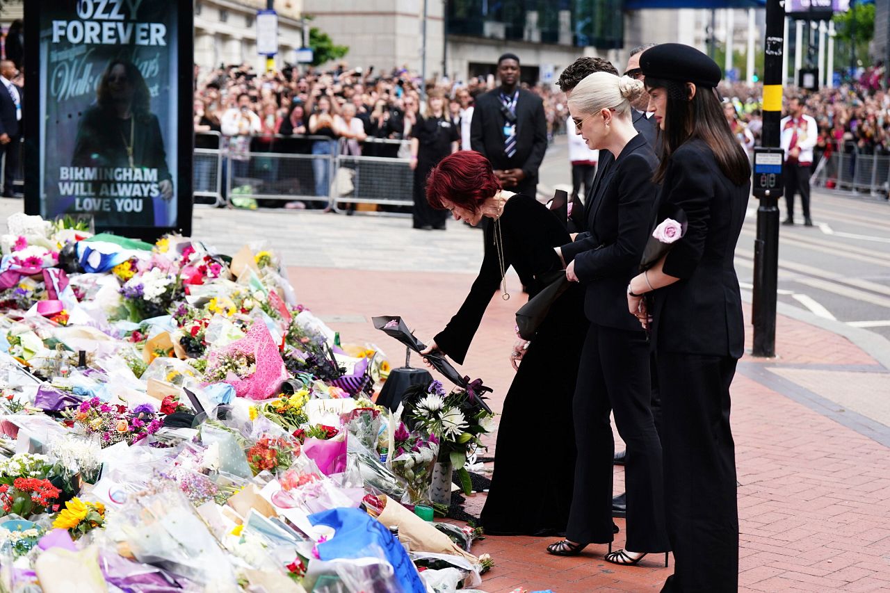 Sharon Osbourne is supported by her children Jack, Kelly and Aimee Osbourne as they lay flowers and view those left by fans
