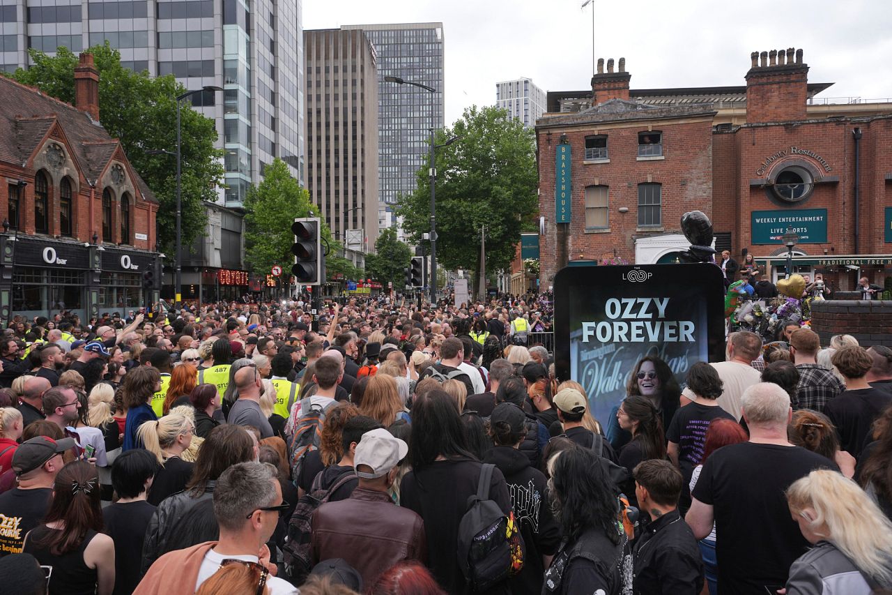Fans gather before the cortege arrives