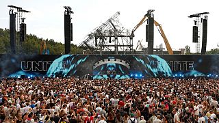 FILE: People listen to DJs Odymel and Pegassi performing at the Tomorrowland music festival in Boom, Belgium, Friday, July 18, 2025.