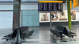 Empty seats and a board showing cancelled flights at Heathrow Terminal 5, 21 March, 2025