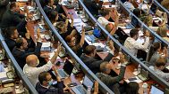 FILE: Kosovo lawmakers vote during the parliament session in Pristina, 7 July 2021