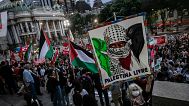 A woman holds a sign that reads in Portuguese "Free Palestine," during an event of solidarity with the Palestinian people in Rio de Janeiro, 19 October, 2023