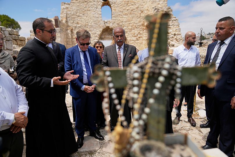 Johann Wadephul speaks to the media in the archaeological site of the Church of St. George in the West Bank, 1 August, 2025