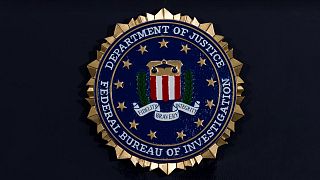 The FBI seal is seen before a news conference at FBI headquarters in Washington, 14 June, 2018