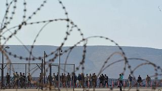 Migrants rescued south of Crete walk after their arrival at the port of Lavrio, 10 July, 2025
