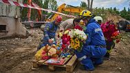 Rescuers lay toys and flowers on the site of Russia's Thursday night missile strike that hit a residential house in Kyiv, 1 August, 2025