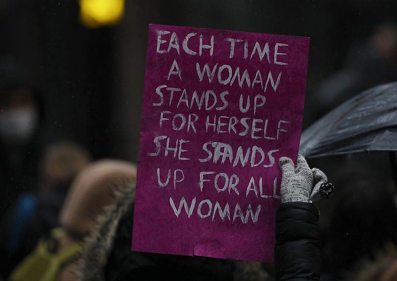 FILE - A woman holds a placard during a protest rally in Ankara, Turkey, Saturday, March 20, 2021. 