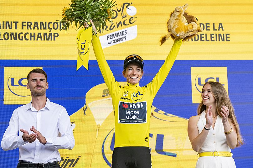 The overall leader Pauline Ferrand-Prevot from France of team Visma - Lease a Bike celebrates on the podium