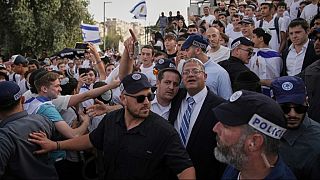 Surrounded by security guards, Israel's far-right National Security Minister, Itamar Ben-Gvir, center, participates in march marking Jerusalem Day, Monday, May 26, 2025