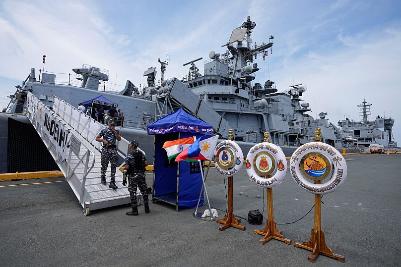A crew disembarks the Indian navy ship guided-missile destroyer, INS Delhi, that is docked at Manila's port, Philippines, on Friday, Aug. 1, 2025.