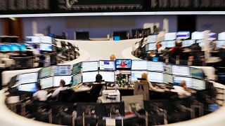 A curve of the German stock index DAX, top, is displayed on a board at the stock market in Frankfurt, Germany. 29 June 2015.