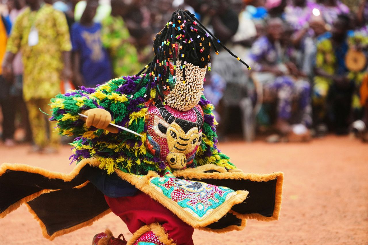 A man dressed in a costume dances during the mask festival in Porto Novo, Benin.