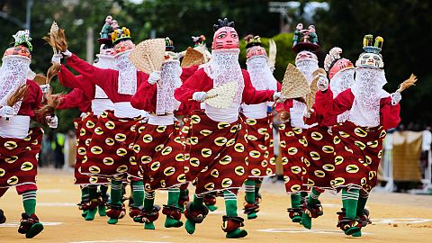 eople dressed in costumes perform during the mask festival in Porto-Novo, Benin.