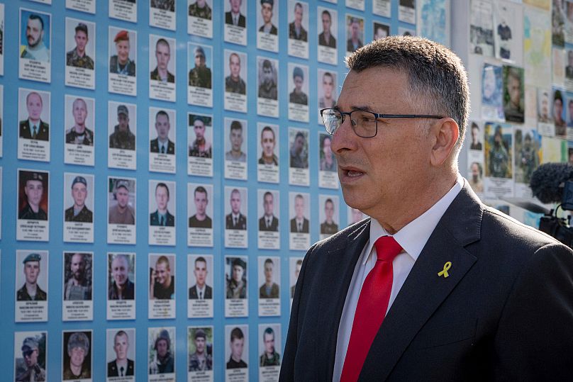 Israel's Foreign Minister Gideon Sa'ar attends a flower laying ceremony at the Memory Wall of Fallen Defenders of Ukraine in Kyiv, 23 July, 2025