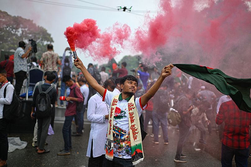 Students use coloured flares as they mark "July Uprising Day" marking the anniversary of the fall of the Awami League government in Dhaka, 5 August, 2025