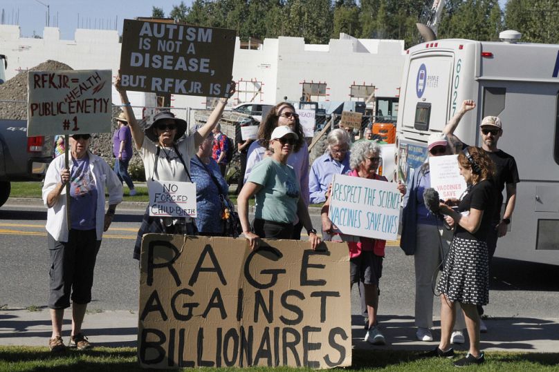 Protesters hold signs and chant outside the Alaska Native Tribal Health Consortium where US Health Secretary Robert F Kennedy Jr met with Native leaders, Tuesday, Aug. 5, 2025