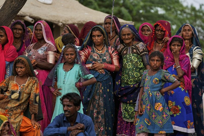 Women prepare to leave after the performance of a Pakistani folk musician Sham Bhai at a village in Umerkot