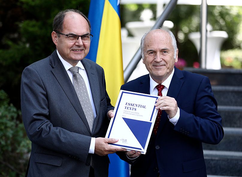 FILE: Christian Schmidt, the new peace envoy to Bosnia, poses with Valentin Inzko, the outgoing head of OHR in Sarajevo, 2 August 2021