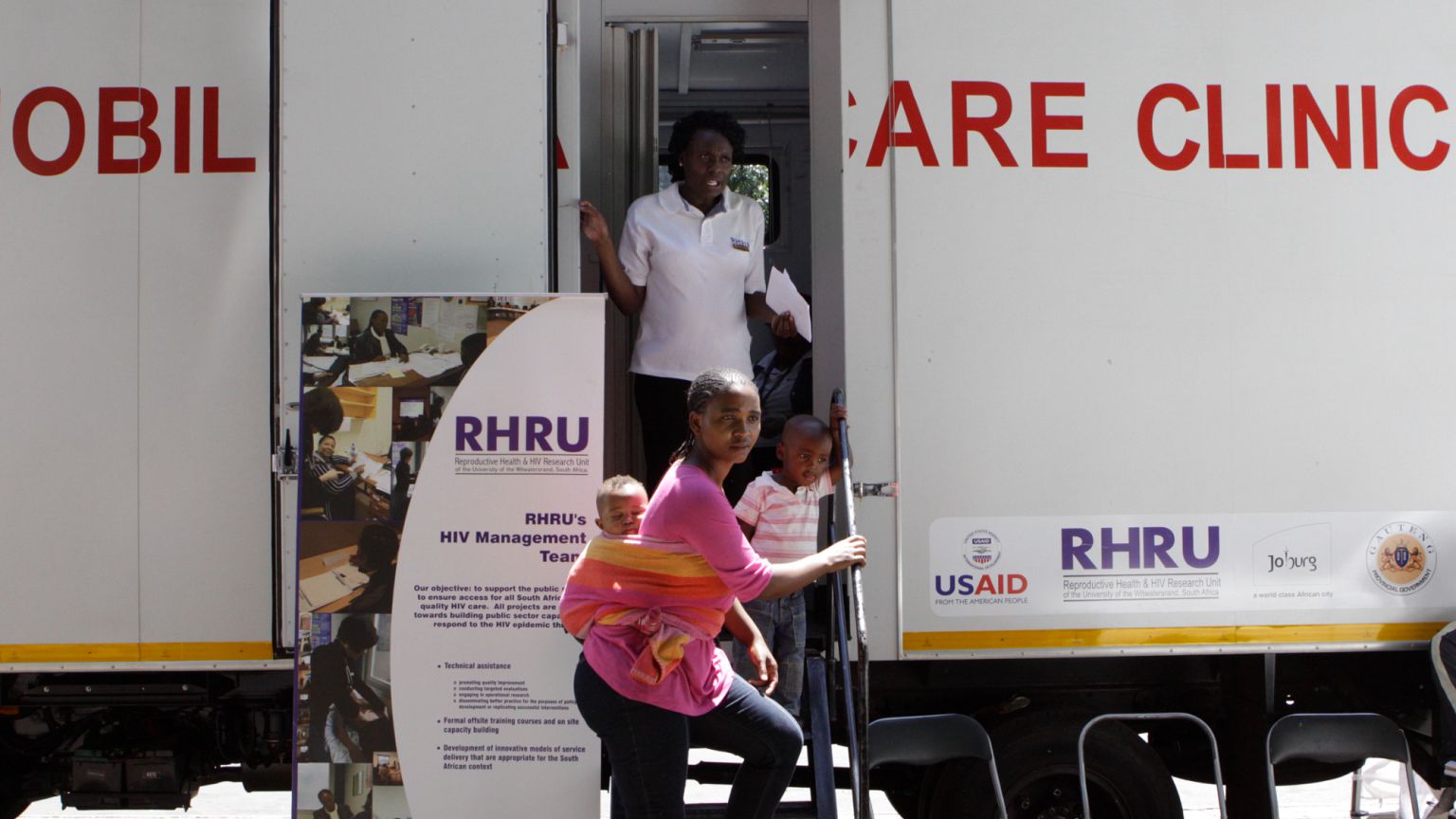 A woman enters a mobile healthcare clinic parked in downtown Johannesburg, South Africa.