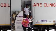 A woman enters a mobile healthcare clinic parked in downtown Johannesburg, South Africa.