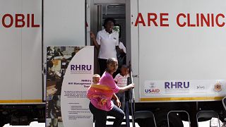 A woman enters a mobile healthcare clinic parked in downtown Johannesburg, South Africa.