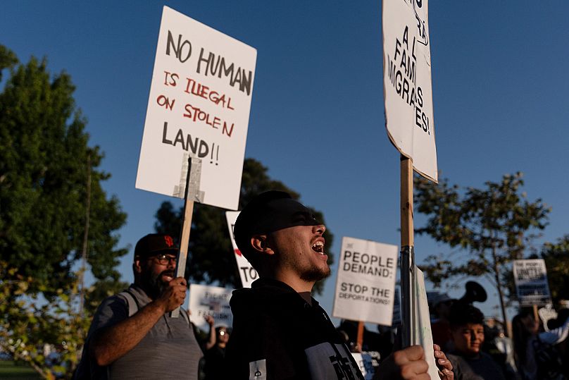 Demonstrators chant slogans while protesting recent immigration raids in Oxnard, California, 18 July 2025. 