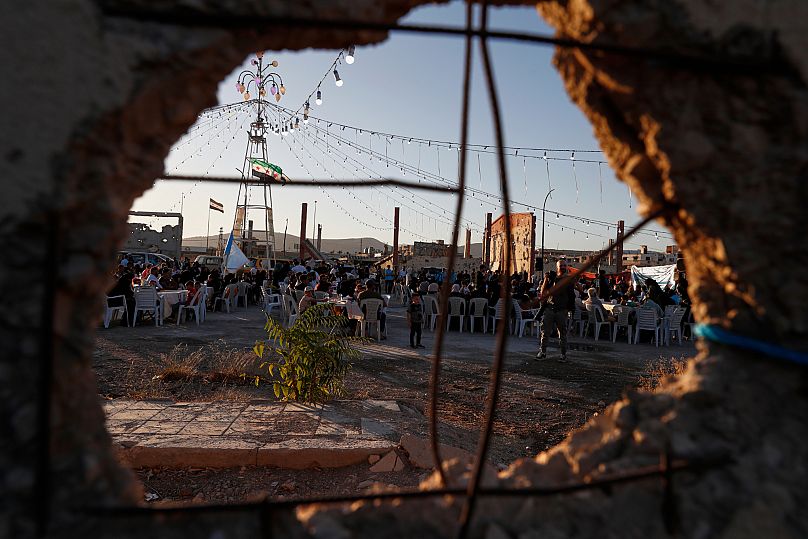 Syrians who had fled their homes during the civil war gather to celebrate their return to their homes in Arbeen, 4 August, 2025