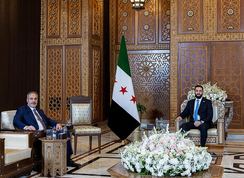 Turkish Foreign Minister Hakan Fidan, left, sits with Syria's interim President Ahmad Al-Sharaa during their meeting in Damascus, 7 August, 2025