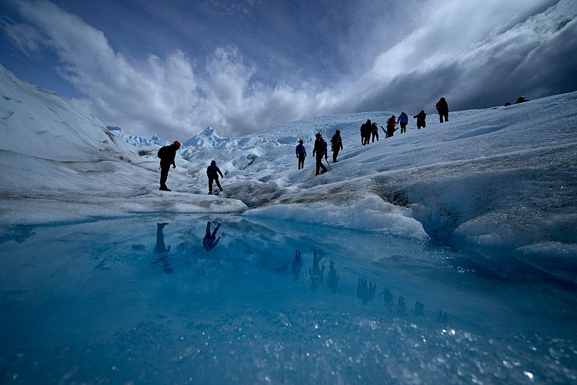 Tourists walk on the Perito Moreno Glacier at Los Glaciares National Park, near El Calafate, Argentina.