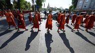 Cambodian Buddhist monks march on a street as they organise a ceremony to honour soldiers killed in recent border clashes with Thai forces, in Cambodia, Friday, Aug. 8, 2025.