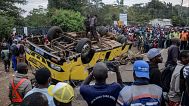 People gather at the scene of a bus accident that overturned in Kisumu, 8 August, 2025