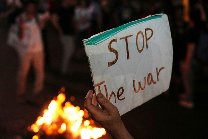Israeli activists protest against the war in the Gaza Strip, Israel's measures regarding food distribution and the forced displacement, in Tel Aviv, Israel, Aug. 7,  2025.