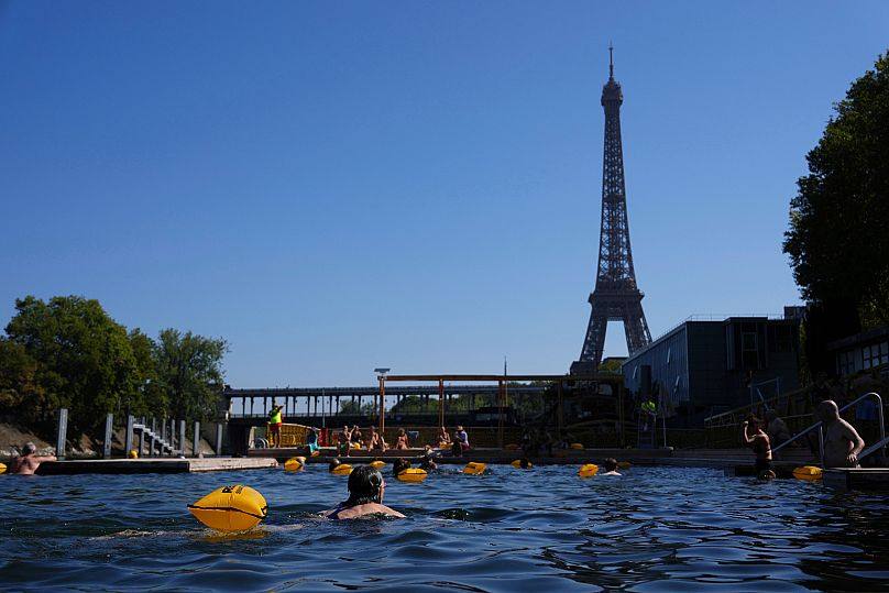 People swim in the Seine river in Paris, 11 August, 2025 