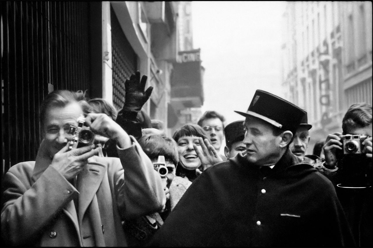 Photographers, fans, and officers, rue de Caumartin, Paris, January 1964