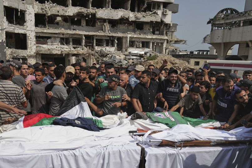 Palestinians mourn over the bodies of Al Jazeera journalists, including Anas al-Sharif, during their funeral outside Gaza City's Shifa hospital complex, Monday, Aug. 11, 2025