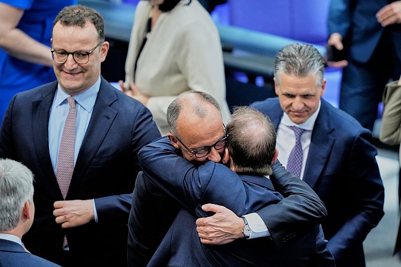 eader of the Christian Democrats Friedrich Merz hugs Alexander Dobrindt from the CSU after being elected new chancellor at the Bundestag in Berlin, 6 May 2025