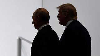  In this June 28, 2019, file photo, President Donald Trump and Russian President Vladimir Putin walk to participate in a group photo at the G20 summit in Osaka, Japan