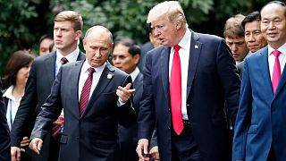 US President Donald Trump and Russia's President Vladimir Putin talk during the family photo session at the APEC Summit in Vietnam in 2017.