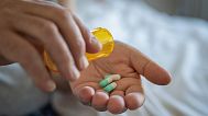 A person prepares to take medication.