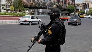 FILE: A member of Iran's Revolutionary Guard stands guard at Enqelab-e-Eslami (Islamic Revolution) square in downtown Tehran, Iran, Tuesday, June 24, 2025.