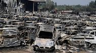 Burned cars are seen at an impound lot in Kato Achaia, during a wildfire near Patras city, western Greece, Wednesday, Aug. 13, 2025. 