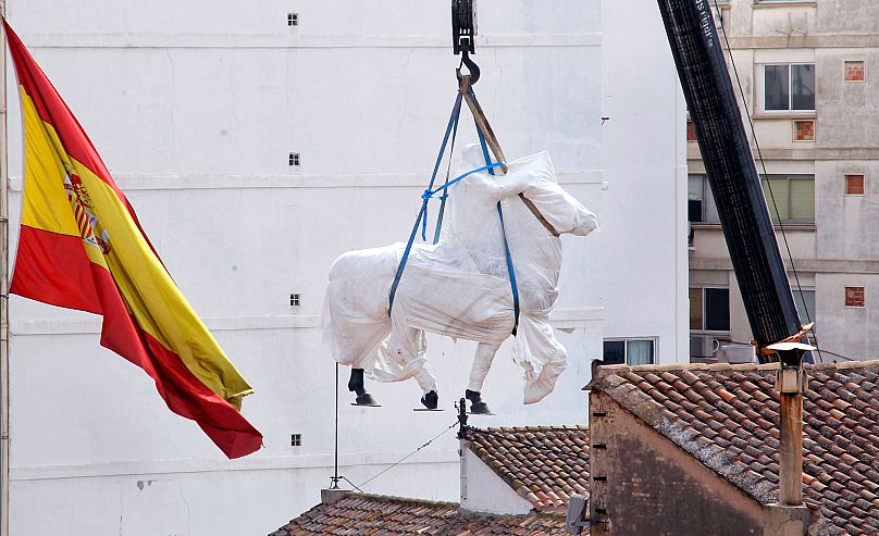 A statue of the late General Francisco Franco being removed by a crane from a military centre in Valencia, Spain. 