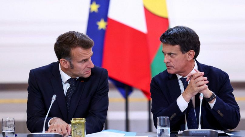 FILE: President Emmanuel Macron, left, and Minister for Overseas Territories Manuel Valls attend a meeting regarding New Caledonia's future in Paris, France, July 12, 2025.