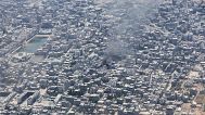 Smoke rises from Gaza City as seen from a Jordanian Air Force C-130 plane during an airdrop of humanitarian aid for Palestinians, 7 August, 2025