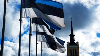 FILE: Estonian national flags flutter in the wind at Freedom Square with the St. John's Church, right in the background, in Tallinn, Estonia, Thursday, Sept. 1, 2022.