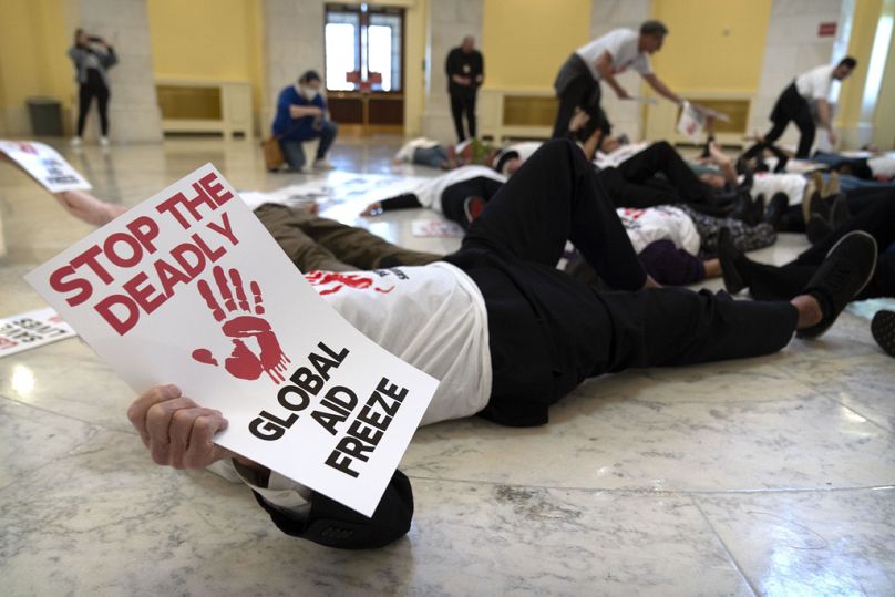 Demonstrators protest against cuts to American foreign aid spending, including USAID and the PEPFAR program to combat HIV/AIDS, at the Cannon House Office Building on Capitol 